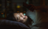 A woman ruining her sleep with blue light